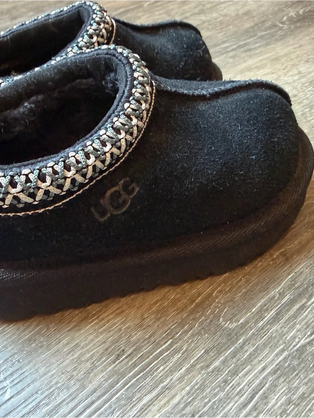 UGG Kids Black Slip-On Moccasin Slippers with Braided Trim
